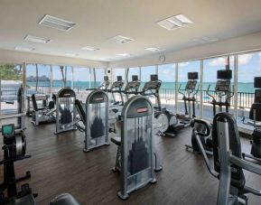 The fitness center in Royal Sonesta San Juan is equipped with a large array of exercise machines, and large windows overlooking the beach.