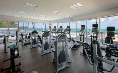 The fitness center in Royal Sonesta San Juan is equipped with a large array of exercise machines, and large windows overlooking the beach.