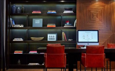 The hotel’s business center is located in the lobby and has a computer workstation and numerous chairs for co-working.