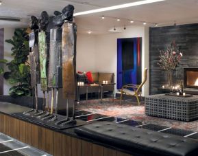The hotel’s lobby is furnished with stylised sculptures, as well as comfortable seating close to a fireplace.
