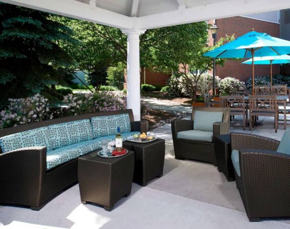The hotel’s patio has shaded tables and chairs, plus armchair and sofa seating under cover and next to coffee tables.