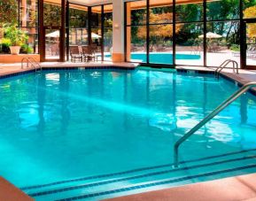 The hotel’s indoor pool has chairs by the side and a direct water link to the outside pool.