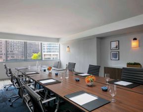 Royal Sonesta Chicago Downtown meeting room, including long table and swivel chairs, with views of the urban landscape.