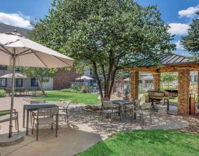 Sonesta ES Suites Denver South - Park Meadows’ patio includes shaded tables and chairs, trees, and a gazebo with barbecue facilities.