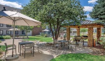 Sonesta ES Suites Denver South - Park Meadows’ patio includes shaded tables and chairs, trees, and a gazebo with barbecue facilities.