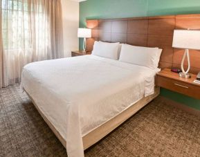 Double bed guest room in Sonesta ES Suites Fort Lauderdale Plantation, including bedside lamps and a window.