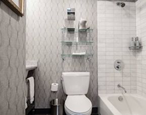 Guest bathroom in The Allegro Royal Sonesta Hotel Chicago Loop, featuring bath and shower, and a lavatory.