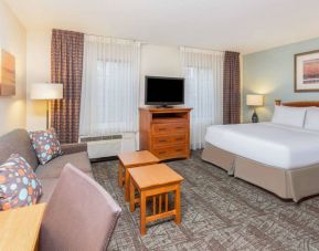 Double bed guest room in Sonesta ES Suites Atlanta - Perimeter Center, including coffee tables, windows, TV, and sofa.