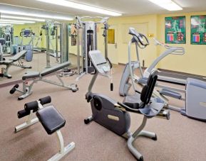 Sonesta Simply Suites Parsippany Morris Plains’ fitness center is equipped with assorted exercise machines, a mirrored wall, and a TV.