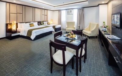 Spacious king room with dining area at Apo View Hotel.