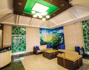 Dreamworld Araneta’s lobby lounge features comfy sofa seating, coffee tables, and art on the wall.