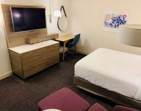 Double bed guest room in Sonesta Columbus Downtown, with workspace desk and chair plus a widescreen television.