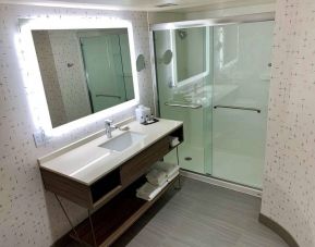 Guest bathroom in Sonesta Columbus Downtown, with shower, sink, and mirror.