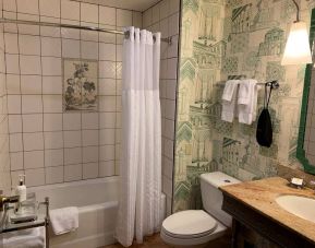 Guest bathroom in Royal Sonesta Portland Downtown, including sink, mirror, lavatory, and bath.