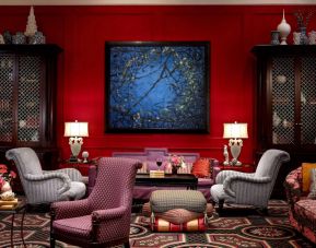 The lobby lounge in Royal Sonesta Portland Downtown is furnished with comfortable armchair and sofa seating, coffee tables, and art on the wall.