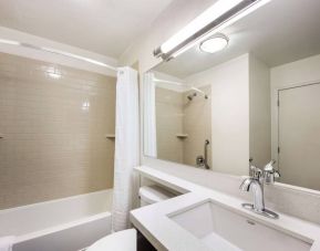 Guest bathroom in Sonesta Simply Suites Houston CityCentre I-10 West, including bath equipped with a shower, mirror, lavatory, and sink.
