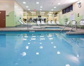 The indoor pool at Sonesta Milwaukee West Wauwatosa has an adjacent hot tub, sun loungers by the side, and is next to the fitness center.
