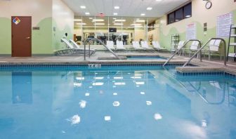 The indoor pool at Sonesta Milwaukee West Wauwatosa has an adjacent hot tub, sun loungers by the side, and is next to the fitness center.