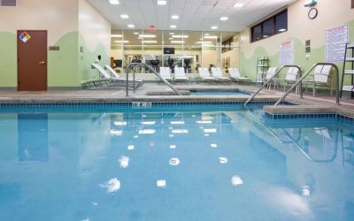 The indoor pool at Sonesta Milwaukee West Wauwatosa has an adjacent hot tub, sun loungers by the side, and is next to the fitness center.