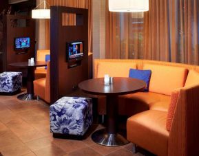 The media pods at Sonesta Select Detroit Auburn Hills are cozy nooks, with each featuring comfy seating, a coffee table, and a TV.