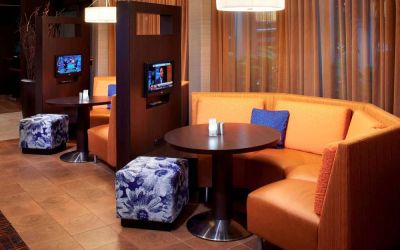 The media pods at Sonesta Select Detroit Auburn Hills are cozy nooks, with each featuring comfy seating, a coffee table, and a TV.