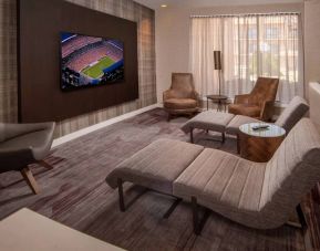 The hotel’s lobby features reclined seats facing a large, wall-mounted TV.