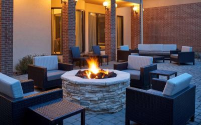 Sonesta Select Indianapolis Carmel’s patio features a fire pit and armchairs, plus coffee tables and sofa seating.