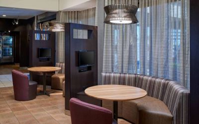 Sonesta Select Indianapolis Carmel’s media pods each feature a TV, coffee table, and comfortable seating next to a window.