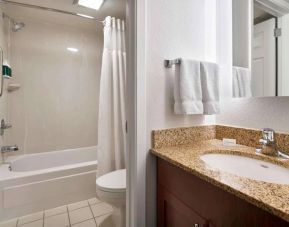 Sonesta ES Suites Annapolis guest bathroom, including a shower-equipped bath, lavatory, mirror, and sink.