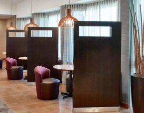 The hotel’s media pods are cozy nooks for socializing or co-working, with comfy seats and coffee tables by the windows.