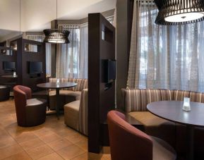 The hotel’s media pods offer a cozy space for co-working, and each has comfy seating, a coffee table, and a television.