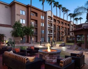 Sonesta Select Phoenix Camelback’s patio features a fire pit surrounded by armchair and sofa seating.