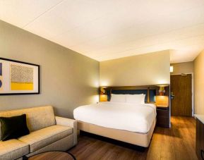 Sonesta Select Philadelphia Airport double bed guest room, furnished with art on the wall and a sofa.