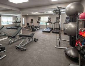 The fitness center at Sonesta ES Suites Fairfax Fair Lakes is equipped with dumbbells, kettlebells, gym balls, and assorted exercise machines.
