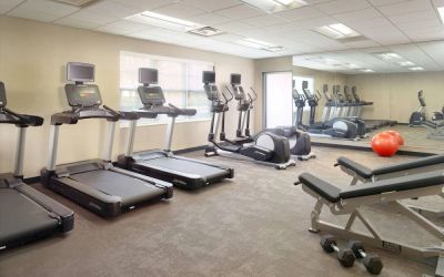 Sonesta ES Suites Raleigh Durham Airport Morrisville’s fitness center is equipped with free weights, benches, and various exercise machines.