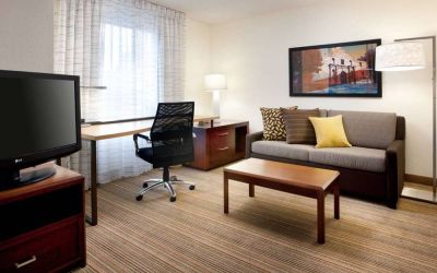 Guest room workspace desk and chair, with TV and sofa nearby, at Sonesta ES Suites San Antonio Downtown Alamo Plaza.