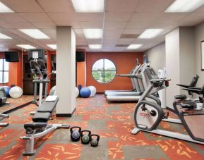 Fitness center with dumbbells, kettlebells, a variety of exercise machines and a TV, at Sonesta ES Suites San Antonio Downtown Alamo Plaza.
