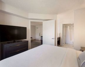 Sonesta ES Suites Reno double bed guest room, including ensuite bathroom and a widescreen TV.