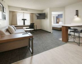 Double bed guest room living area in Sonesta ES Suites Fort Worth Fossil Creek, including sofa, window, and wall-mounted TV.