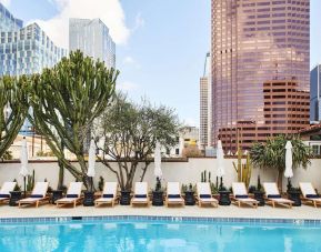 Relaxing outdoor pool with pool chairs at Hotel Figueroa.