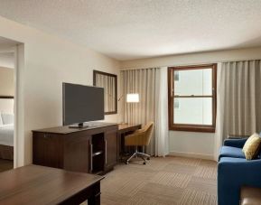 Spacious king room with lounge and work area at Hampton Inn & Suites Springdale.