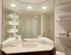 Guest bathroom with shower at Hampton Inn & Suites Springdale.