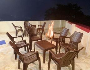 Lounge and coworking space with fire at Pradhan Stay Sohna Near Bus Stand.