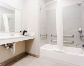 Guest bathroom with shower and bath at Express Inn - Spring.