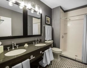 Guest bathroom with shower at EnVision Hotel St. Paul South.
