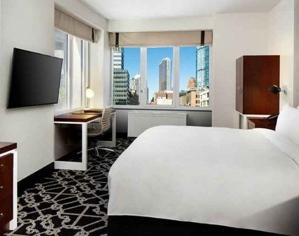 King bed with TV and natural light at Hilton Brooklyn New York.