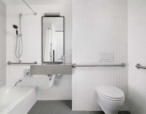 Guest bathroom with shower and bath at Arlo SoHo.
