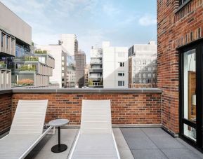 Outdoor terrace with lounge chairs at Arlo SoHo.
