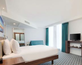 Day room with TV and natural light at Hampton By Hilton London Stansted Airport.