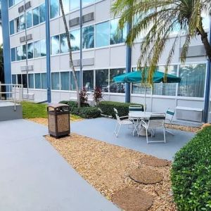 Outdoor garden and terrace at EnVision Hotel Miami International Airport.